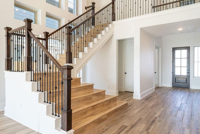 15842 Formaston Forest Dr, Humble, TX 77346 - stairs with a high ceiling, baseboards, and wood finished floors
