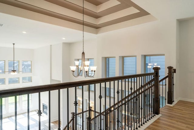 15842 Formaston Forest Dr, Humble, TX 77346 - corridor with an upstairs landing, a chandelier, a towering ceiling, wood finished floors, and baseboards