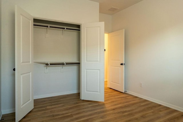15842 Formaston Forest Dr, Humble, TX 77346 - unfurnished bedroom featuring wood finished floors, a closet, and baseboards