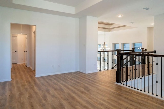 15842 Formaston Forest Dr, Humble, TX 77346 - spare room with a chandelier, a tray ceiling, wood finished floors, baseboards, and recessed lighting