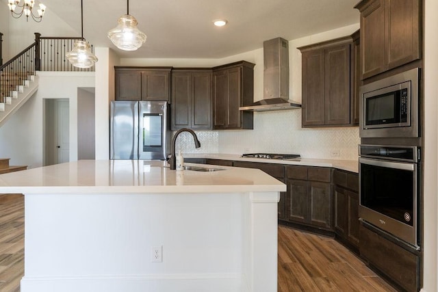 15842 Formaston Forest Dr, Humble, TX 77346 - kitchen featuring stainless steel appliances, wall chimney exhaust hood, a sink, dark brown cabinets, and light countertops