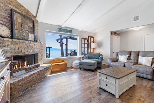 246 Indian Falls Ln, Livingston, TX 77351 - living room featuring a brick fireplace, wood finished floors, and baseboards