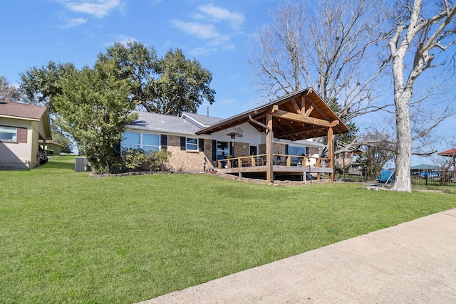 246 Indian Falls Ln, Livingston, TX 77351 - rear view of house featuring a lawn and central air condition unit