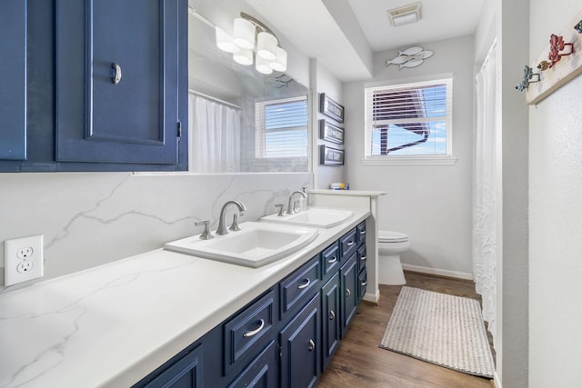 246 Indian Falls Ln, Livingston, TX 77351 - full bath with double vanity, wood finished floors, toilet, and baseboards