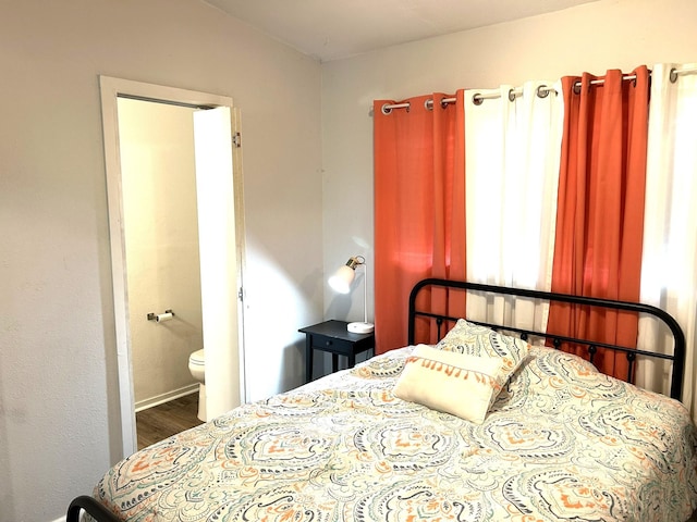 320 Deer Run Rd, Trinity, TX 75862 - bedroom with wood finished floors, connected bathroom, and baseboards