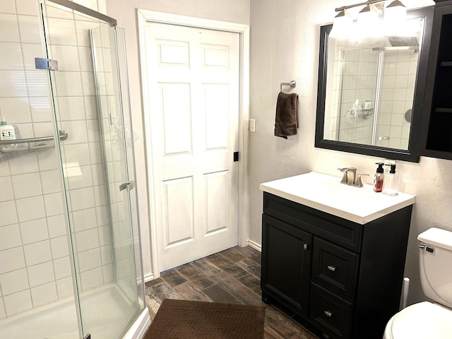320 Deer Run Rd, Trinity, TX 75862 - full bathroom featuring toilet, wood finished floors, a stall shower, and vanity