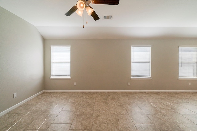 1603 N City Oaks Ln, Houston, TX 77047 - empty room with healthy amount of natural light, lofted ceiling, a ceiling fan, and light tile patterned floors
