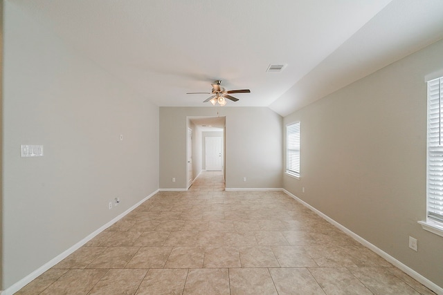 1603 N City Oaks Ln, Houston, TX 77047 - empty room with ceiling fan, vaulted ceiling, light tile patterned floors, and baseboards