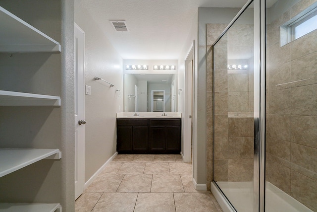 1603 N City Oaks Ln, Houston, TX 77047 - full bathroom with double vanity, a shower stall, tile patterned floors, and baseboards