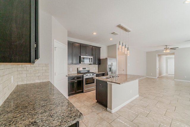 1603 N City Oaks Ln, Houston, TX 77047 - kitchen with stainless steel appliances, tasteful backsplash, ceiling fan, light tile patterned floors, and light stone countertops