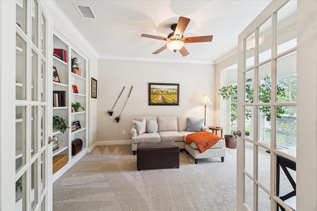 2122 Misty River Trl, Kingwood, TX 77345 - living room featuring french doors, carpet, ornamental molding, ceiling fan, and baseboards