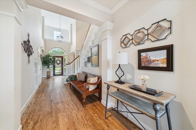 2122 Misty River Trl, Kingwood, TX 77345 - entrance foyer with wood finished floors, baseboards, stairway, a towering ceiling, and ornamental molding