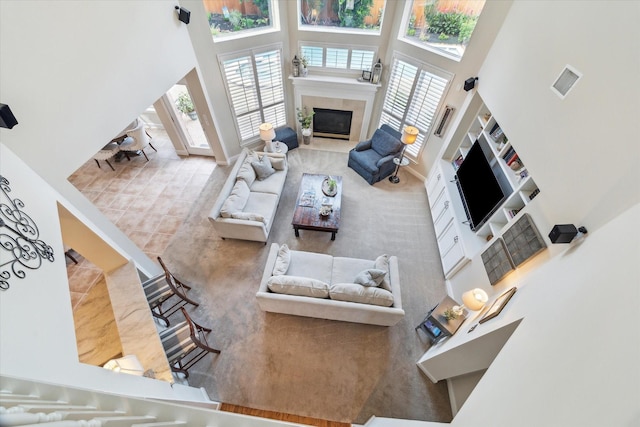 2122 Misty River Trl, Kingwood, TX 77345 - living room featuring a towering ceiling, healthy amount of natural light, a fireplace, and baseboards