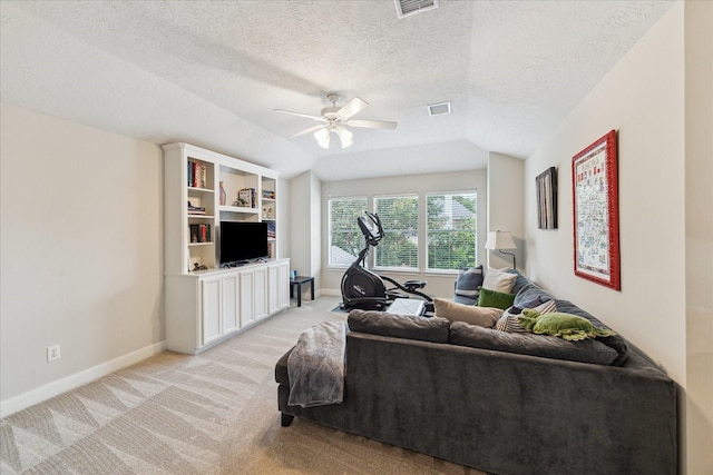 2122 Misty River Trl, Kingwood, TX 77345 - living area featuring light carpet, ceiling fan, lofted ceiling, baseboards, and a textured ceiling