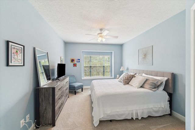 2122 Misty River Trl, Kingwood, TX 77345 - bedroom with light carpet, a textured ceiling, ceiling fan, and baseboards