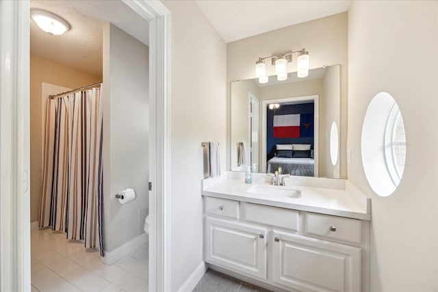 2122 Misty River Trl, Kingwood, TX 77345 - bathroom with vanity, ensuite bathroom, toilet, tile patterned flooring, and baseboards