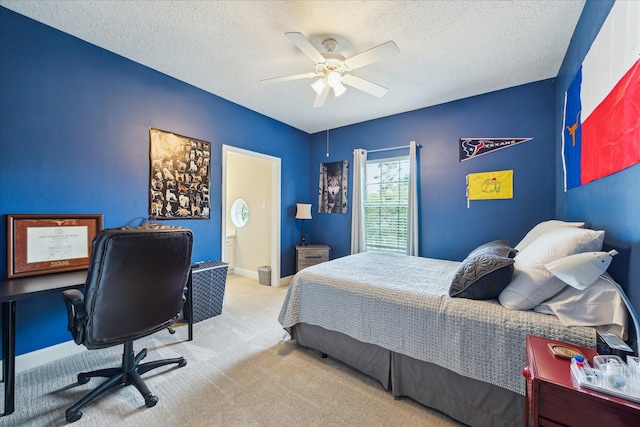 2122 Misty River Trl, Kingwood, TX 77345 - carpeted bedroom featuring an office area, a textured ceiling, ceiling fan, and ensuite bath