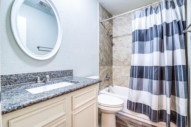 828 Noreda St, Angleton, TX 77515 - full bath with toilet, shower / bath combo with shower curtain, vanity, wood finished floors, and a textured ceiling