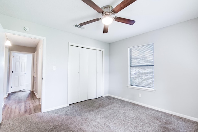 828 Noreda St, Angleton, TX 77515 - unfurnished bedroom featuring carpet, baseboards, a closet, and a ceiling fan