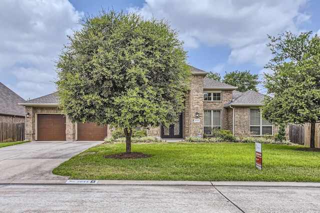 2044 Doolan Dr, Conroe, TX 77301 - view of front of house featuring driveway, an attached garage, roof with shingles, and brick siding