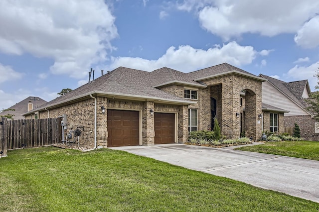 2044 Doolan Dr, Conroe, TX 77301 - french provincial home featuring brick siding, roof with shingles, a garage, and driveway