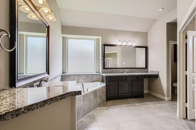 2044 Doolan Dr, Conroe, TX 77301 - bathroom featuring vanity, a garden tub, toilet, and baseboards