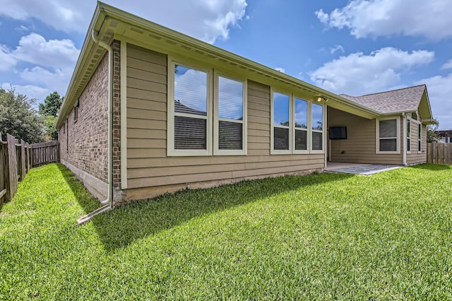 2044 Doolan Dr, Conroe, TX 77301 - rear view of house with a patio and brick siding