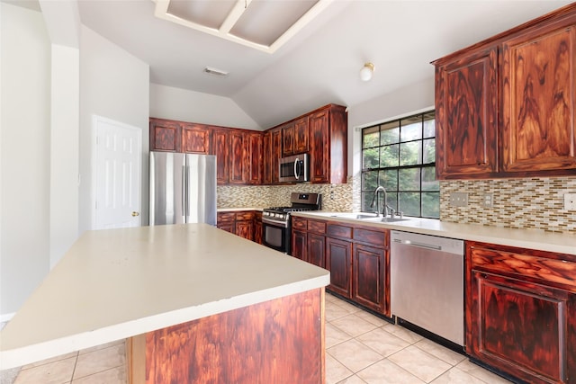 2606 Spring Chase Dr, Spring, TX 77386 - kitchen featuring stainless steel appliances, a sink, light tile patterned floors, vaulted ceiling, and light countertops