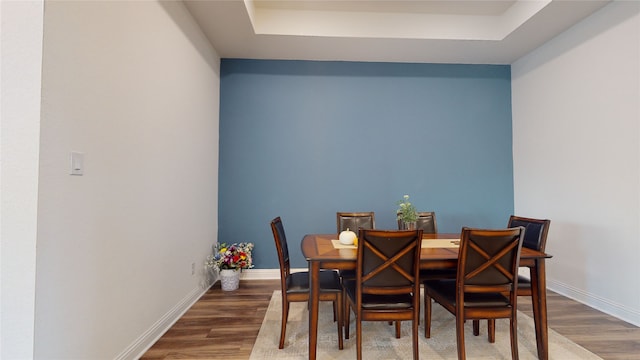 2002 Village Orchard Ln, Katy, TX 77423 - dining area with wood finished floors, a raised ceiling, and baseboards