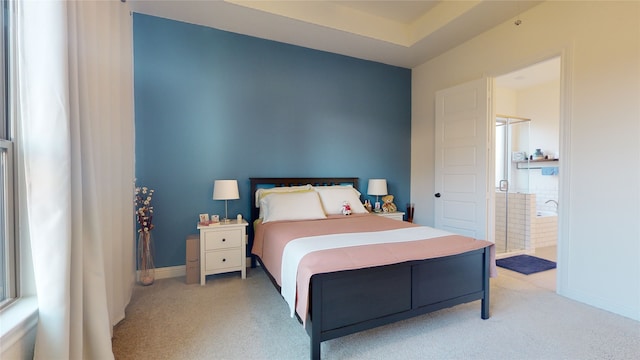 2002 Village Orchard Ln, Katy, TX 77423 - bedroom with light carpet, baseboards, and ensuite bath