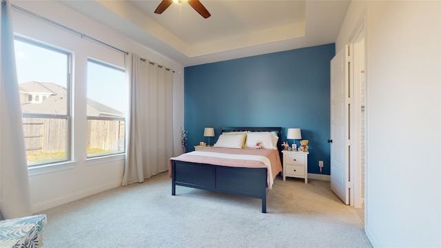 2002 Village Orchard Ln, Katy, TX 77423 - bedroom featuring light carpet, a raised ceiling, a ceiling fan, and baseboards