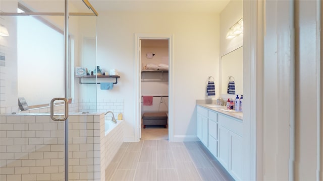 2002 Village Orchard Ln, Katy, TX 77423 - bathroom with vanity, a bath, a shower stall, a spacious closet, and tile patterned floors