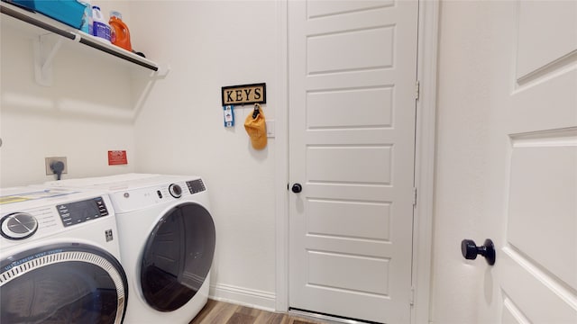 2002 Village Orchard Ln, Katy, TX 77423 - laundry area featuring washer and dryer, wood finished floors, and baseboards