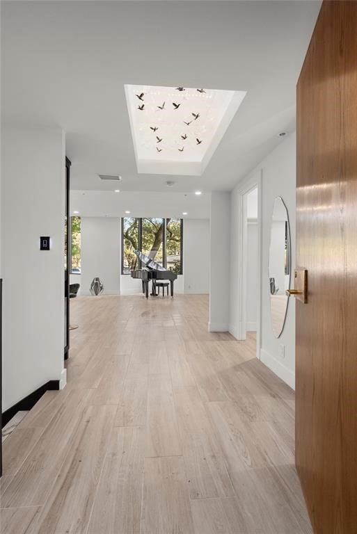 5555 Del Monte Dr Unit 103, Houston, TX 77056 - hall with a tray ceiling, light wood-style flooring, baseboards, and recessed lighting