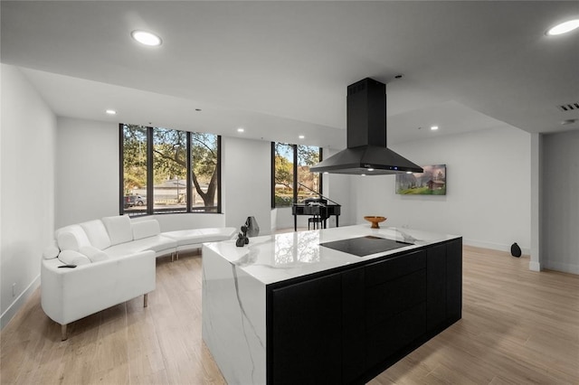 5555 Del Monte Dr Unit 103, Houston, TX 77056 - kitchen with dark cabinets, island range hood, modern cabinets, a center island, and baseboards