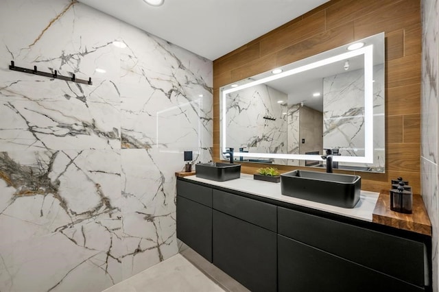 5555 Del Monte Dr Unit 103, Houston, TX 77056 - full bath with double vanity, a marble finish shower, and tile walls