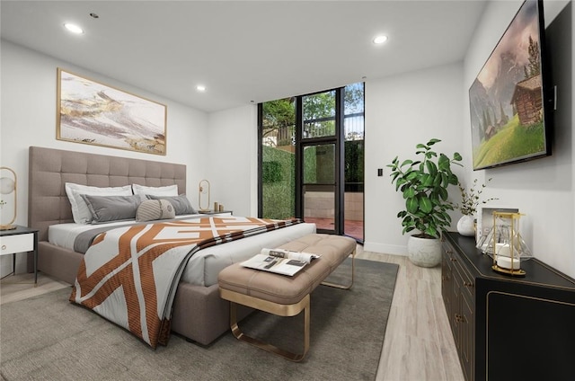 5555 Del Monte Dr Unit 103, Houston, TX 77056 - bedroom featuring recessed lighting, expansive windows, light wood-style flooring, access to outside, and baseboards