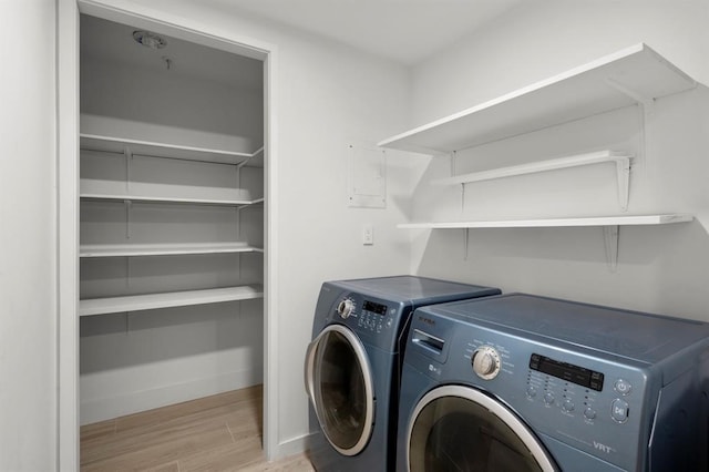 5555 Del Monte Dr Unit 103, Houston, TX 77056 - laundry room with separate washer and dryer, wood finished floors, and baseboards