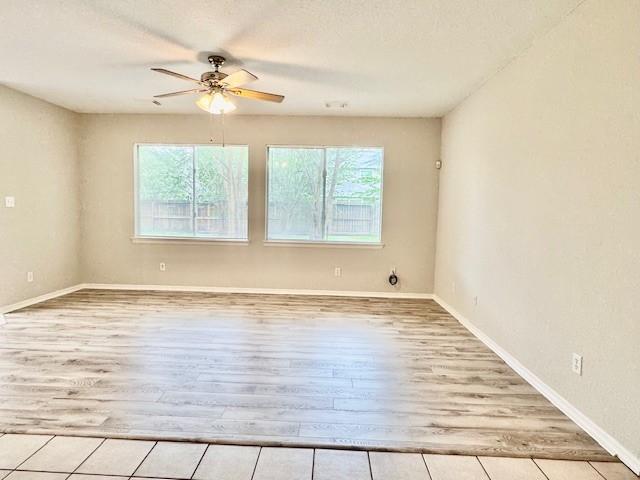 1119 Autumn Green Dr, Missouri City, TX 77459 - unfurnished room with plenty of natural light, wood finished floors, a ceiling fan, and baseboards