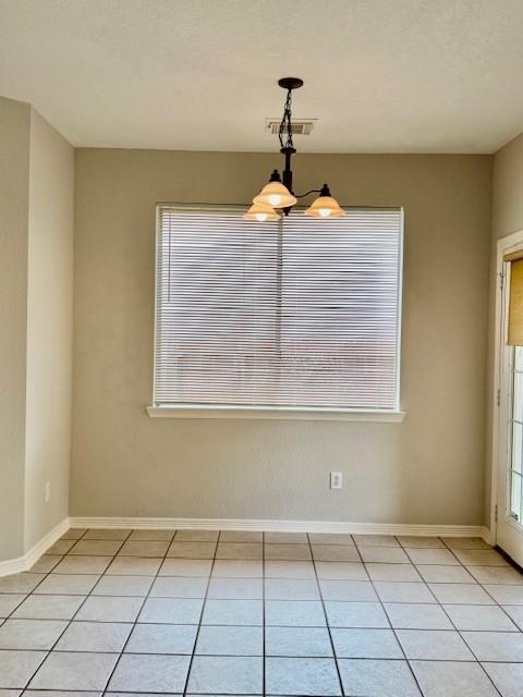 1119 Autumn Green Dr, Missouri City, TX 77459 - unfurnished room with a chandelier, light tile patterned flooring, and baseboards