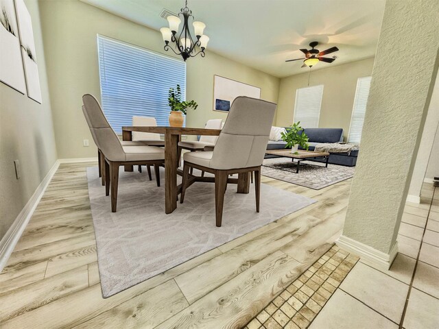 1119 Autumn Green Dr, Missouri City, TX 77459 - dining area featuring a ceiling fan, baseboards, a chandelier, and wood finished floors