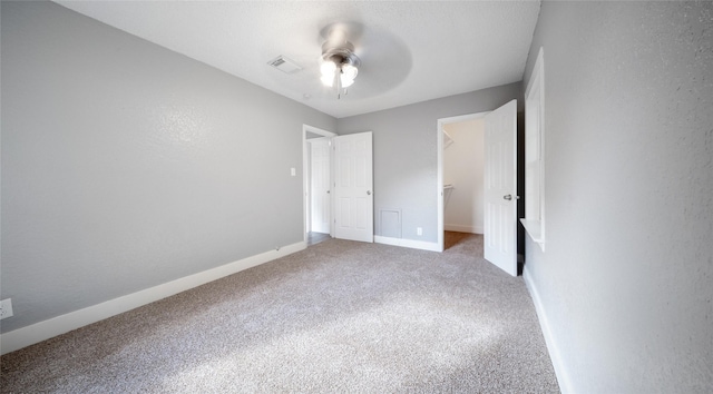 306 W Wilkins St, League City, TX 77573 - unfurnished bedroom with carpet, a spacious closet, baseboards, ceiling fan, and a closet