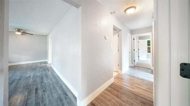 306 W Wilkins St, League City, TX 77573 - hallway featuring a textured ceiling, a textured wall, wood finished floors, and baseboards
