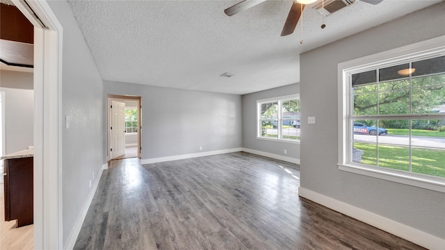 306 W Wilkins St, League City, TX 77573 - unfurnished room featuring ceiling fan, wood finished floors, a textured ceiling, and baseboards