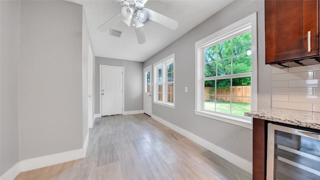 306 W Wilkins St, League City, TX 77573 - entryway featuring beverage cooler, plenty of natural light, baseboards, and ceiling fan