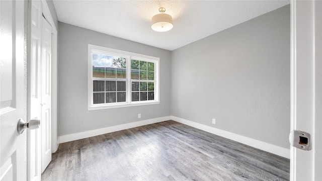 306 W Wilkins St, League City, TX 77573 - unfurnished room with wood finished floors and baseboards