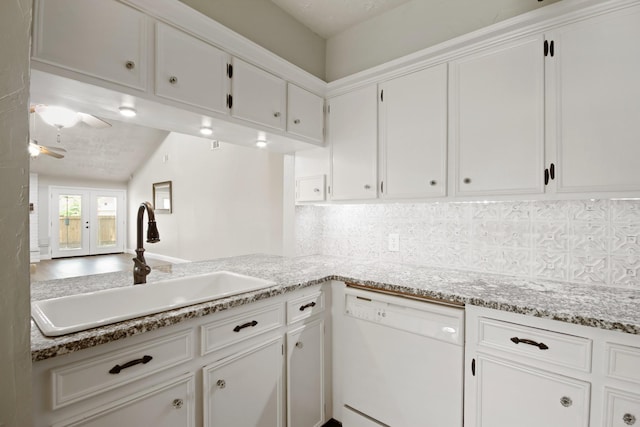 14922 Sandy Creek Dr, Houston, TX 77070 - kitchen with white dishwasher, a sink, white cabinets, and decorative backsplash