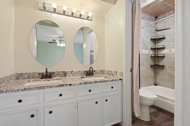 14922 Sandy Creek Dr, Houston, TX 77070 - bathroom with double vanity, a ceiling fan, toilet, wood finished floors, and shower / bath combination with curtain