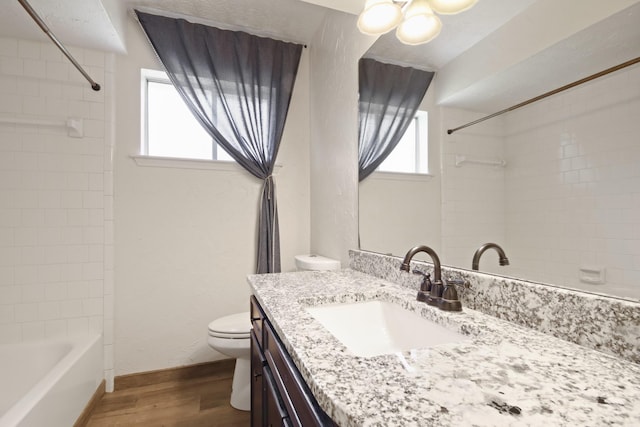14922 Sandy Creek Dr, Houston, TX 77070 - bathroom with wood finished floors, vanity, toilet, bathing tub / shower combination, and baseboards