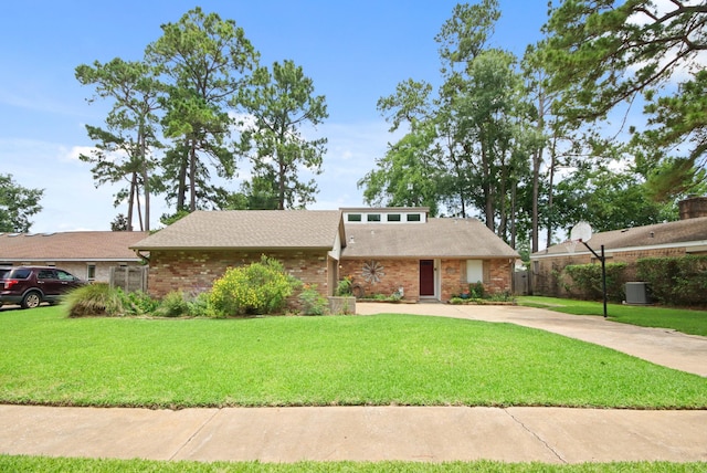 14922 Sandy Creek Dr, Houston, TX 77070 - mid-century home featuring a front lawn, concrete driveway, brick siding, and roof with shingles